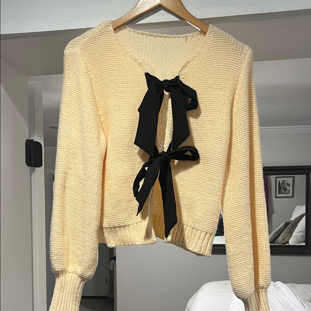 Elegant Cream Sweater with Black Bow Accents